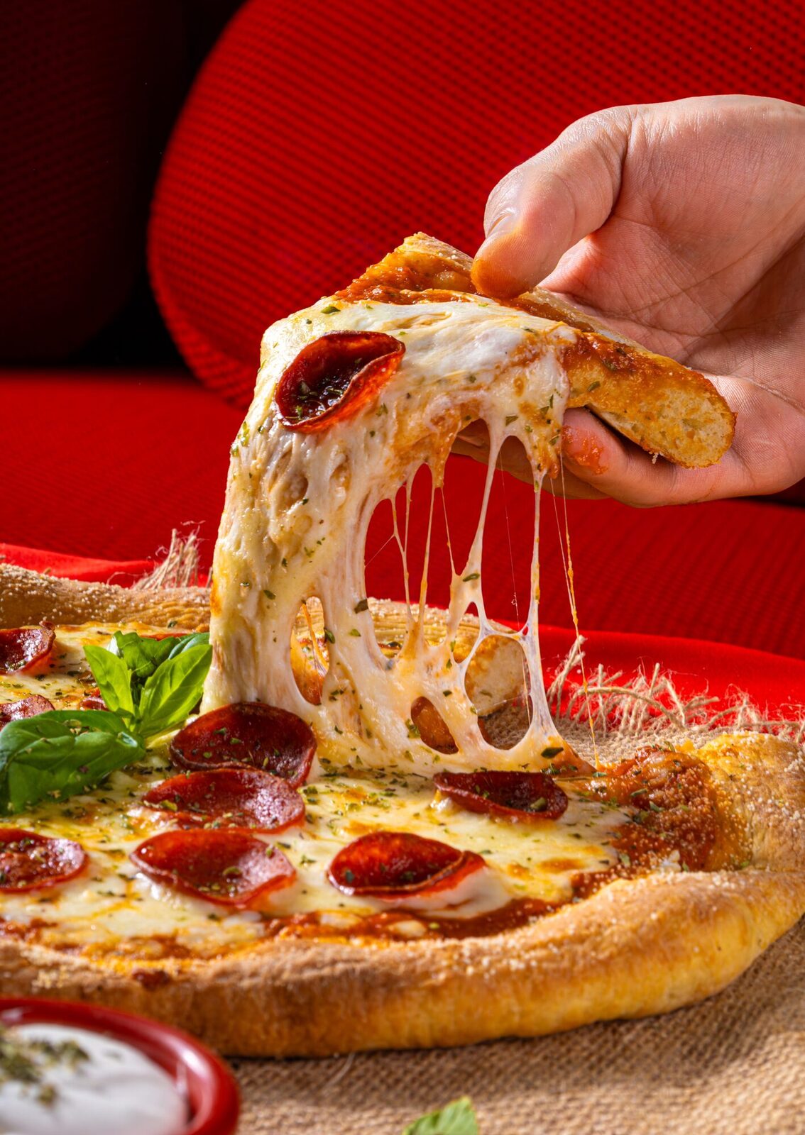 Chef pulling fresh pizza from a wood-fired oven
