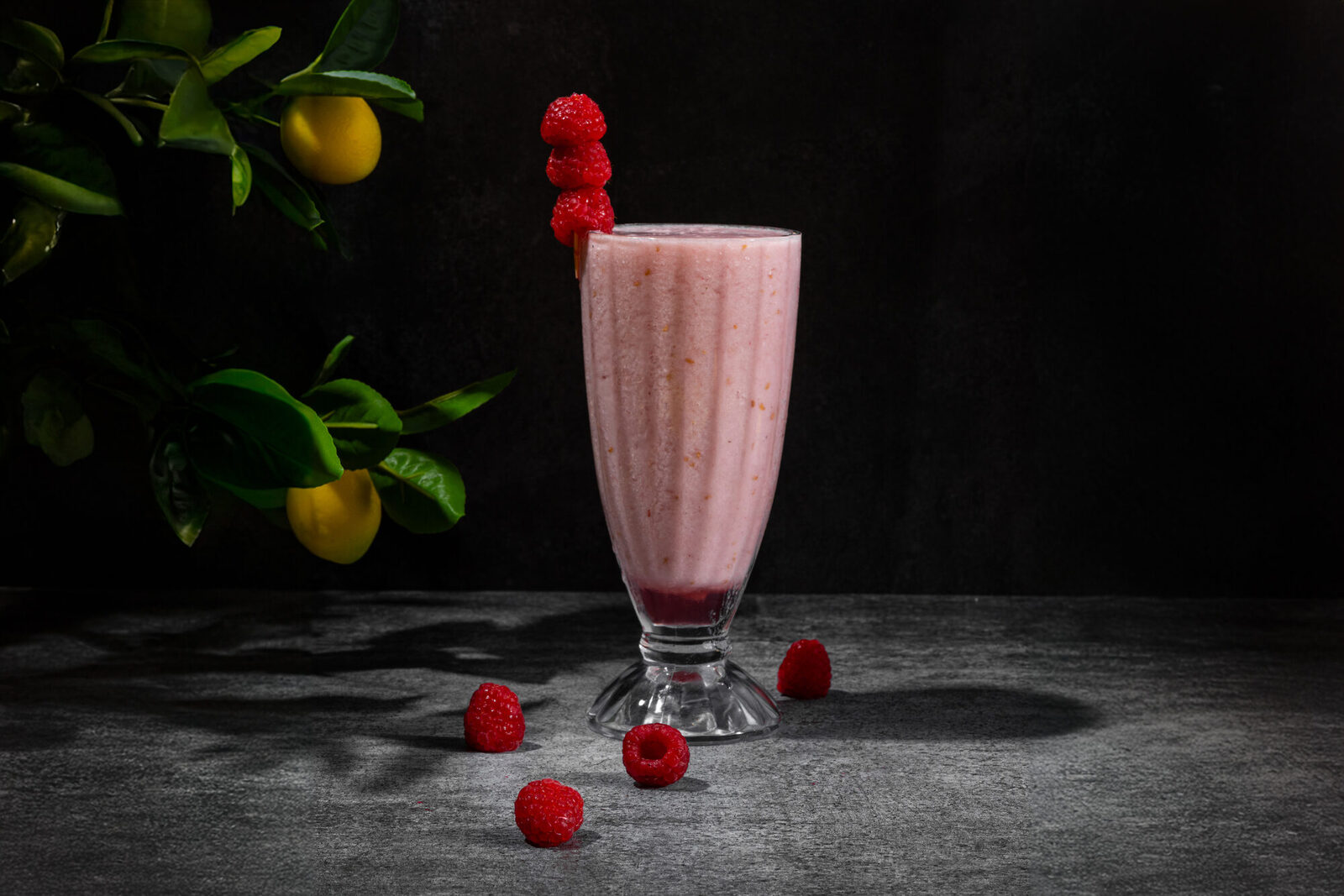 Raspberry dessert plated with blush-colored sauce